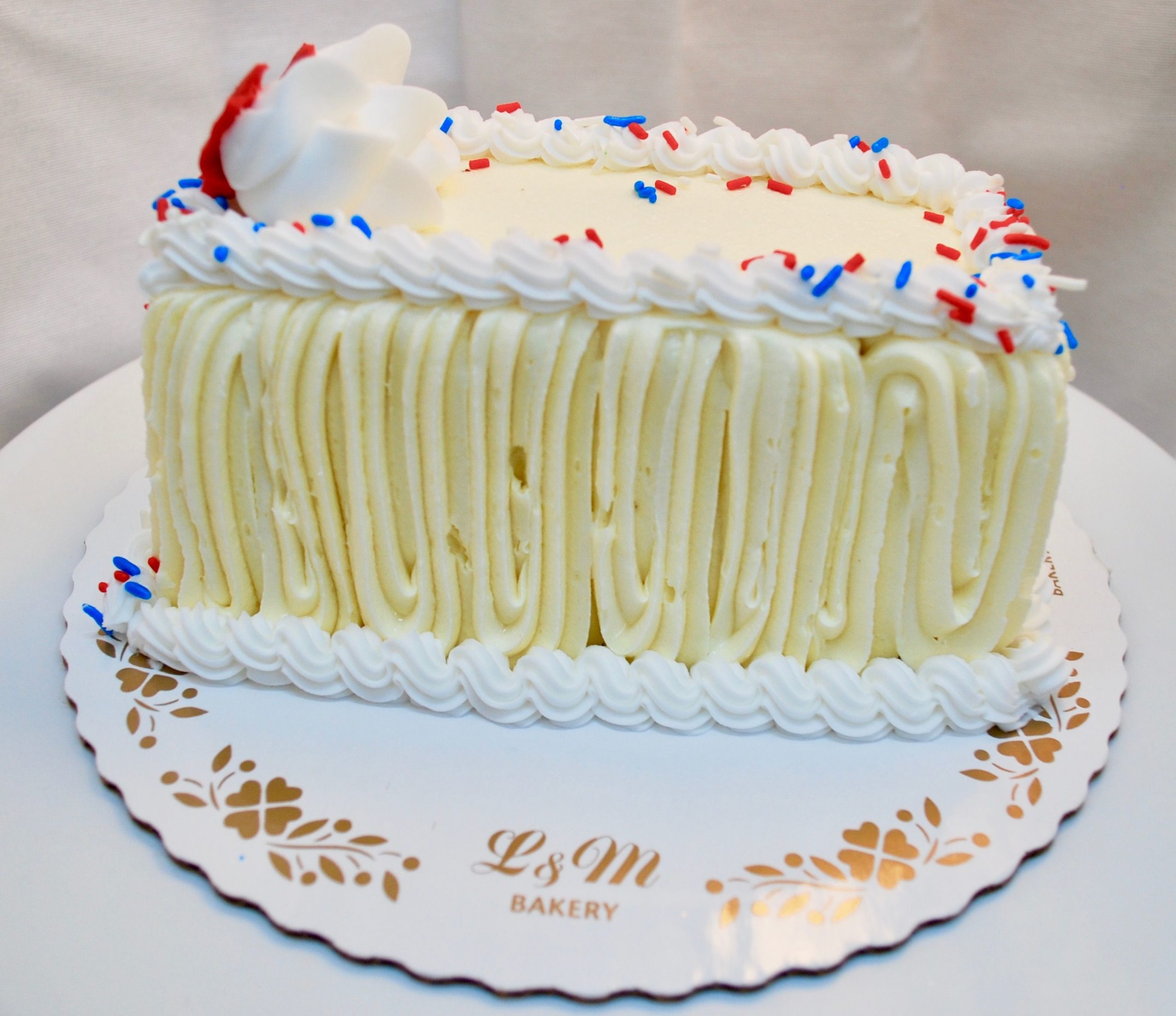 Red, white and blue pound cake on a white display board.