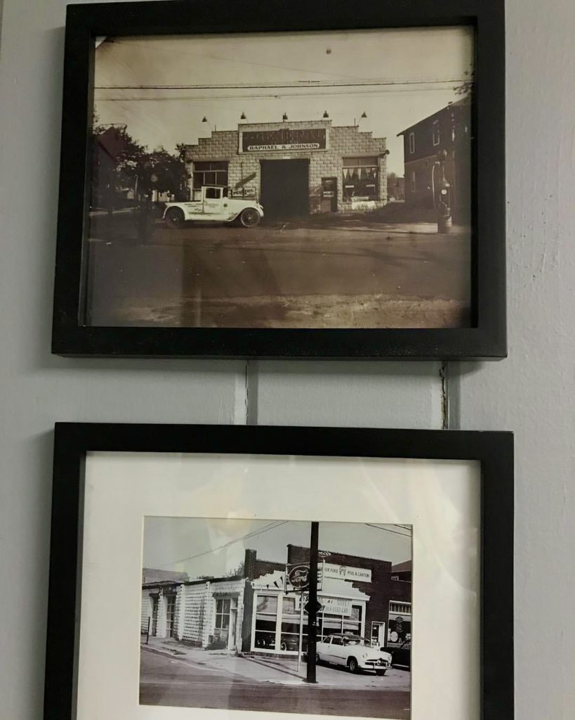 Two frames on a white wall with old pictures of a building in them.