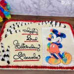 Mickey Mouse picture cake on a wooden table.