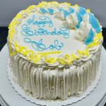 Blue and yellow cake that says, "Happy Birthday Bob".