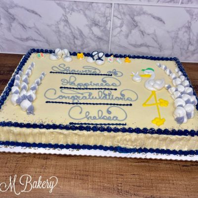 Blue and white baby shower cake on a white display board.