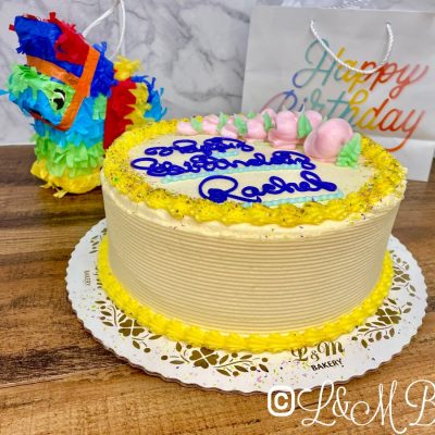 Colorful birthday cake on a wooden table.