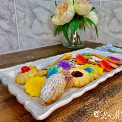 Assorted butter cookies on a white tray.