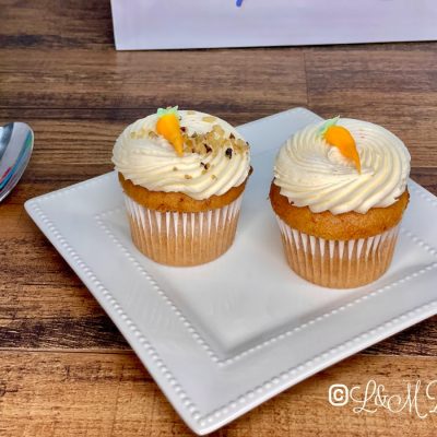 Carrot cake cupcakes on a white serving tray.