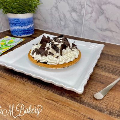 Chocolate custard pie on a white serving tray.