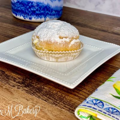 Cream puff on a white serving tray.