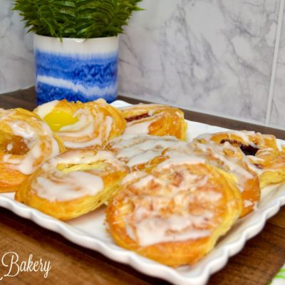 Assorted Danish on a white serving tray.