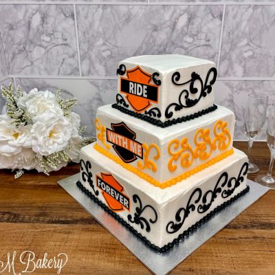 Harley Davidson wedding cake on a wooden table.
