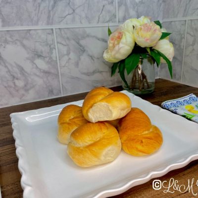 Knot rolls on a white serving tray.