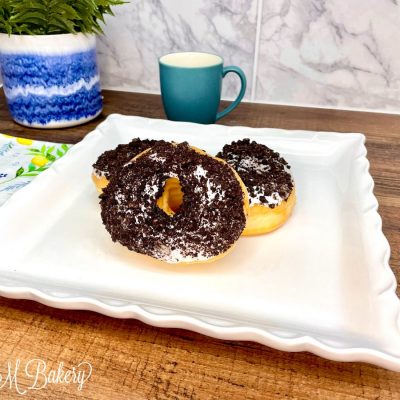 Oreo donut on a white serving tray.
