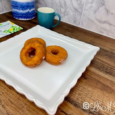 Plain cruller on a white serving tray.